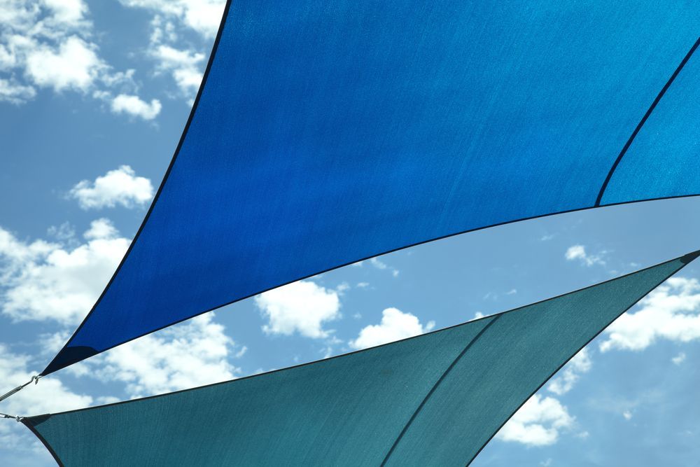 Blue And Green Shade Sail Against The Sky