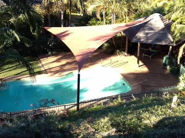 An Aerial View of A Swimming Pool with A Canopy Over It — Jon Wilson Canvas & Shade in Coffs Harbour, NSW