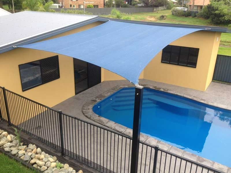 A Swimming Pool with A Blue Shade Over It — Jon Wilson Canvas & Shade in Coffs Harbour, NSW