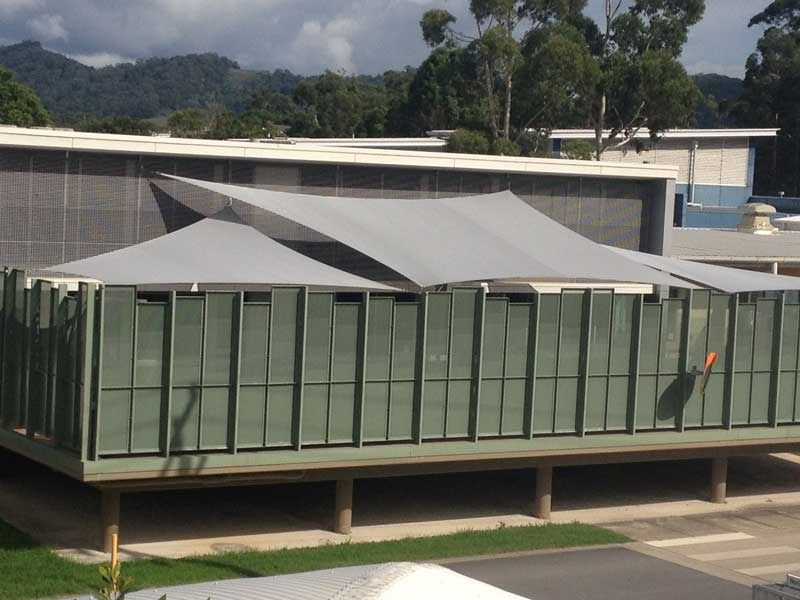 A Building with A Lot of Windows and Shades on It — Jon Wilson Canvas & Shade in Coffs Harbour, NSW