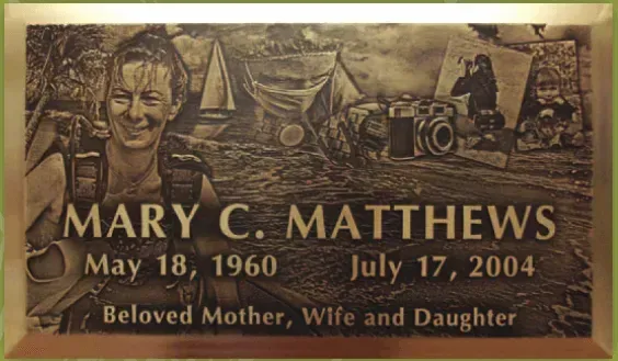 Memorial plaque for Mary C. Matthews with dates May 18, 1960 and July 17, 2004, “Beloved Mother, Wife and Daughter.”