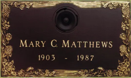 Maroon memorial plaque with gold trim reading “Mary C. Matthews 1903–1987”