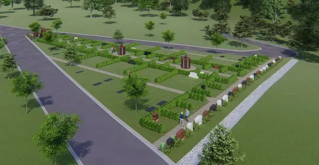 Aerial view of a landscaped park with pathways, trees, lawns, and small garden structures near a road.