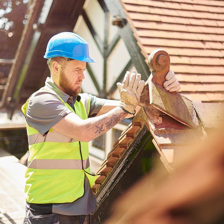 Man Repairing Roof — Spokane Valley, WA — Garcia Roofing Man Repairing Roof — Spokane Valley, WA — Garcia Roofing