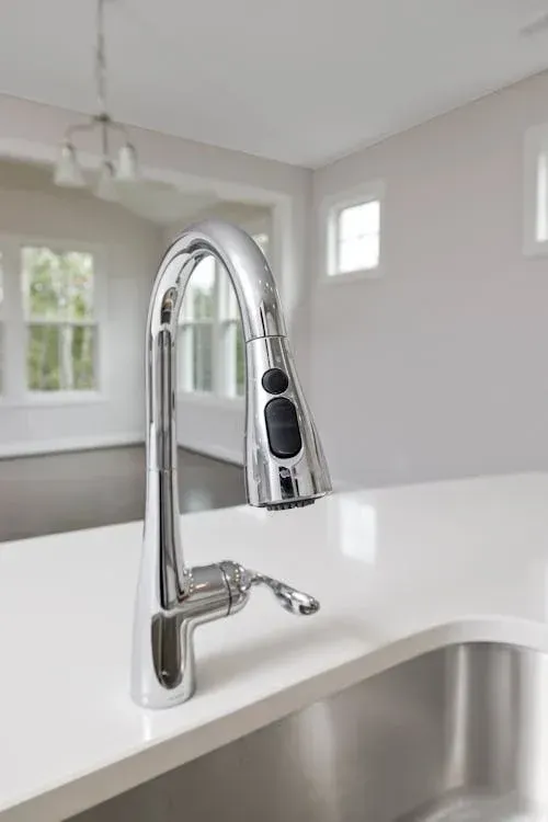 A Kitchen Sink With a Chrome Faucet and a White Countertop — Andergrove Plumbing & Drainage Pty Ltd In Richmond, QLD