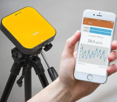 Man working on ceiling HVAC unit. He’s reaching up, wires hanging down. Metal grid ceiling, visible insulation.