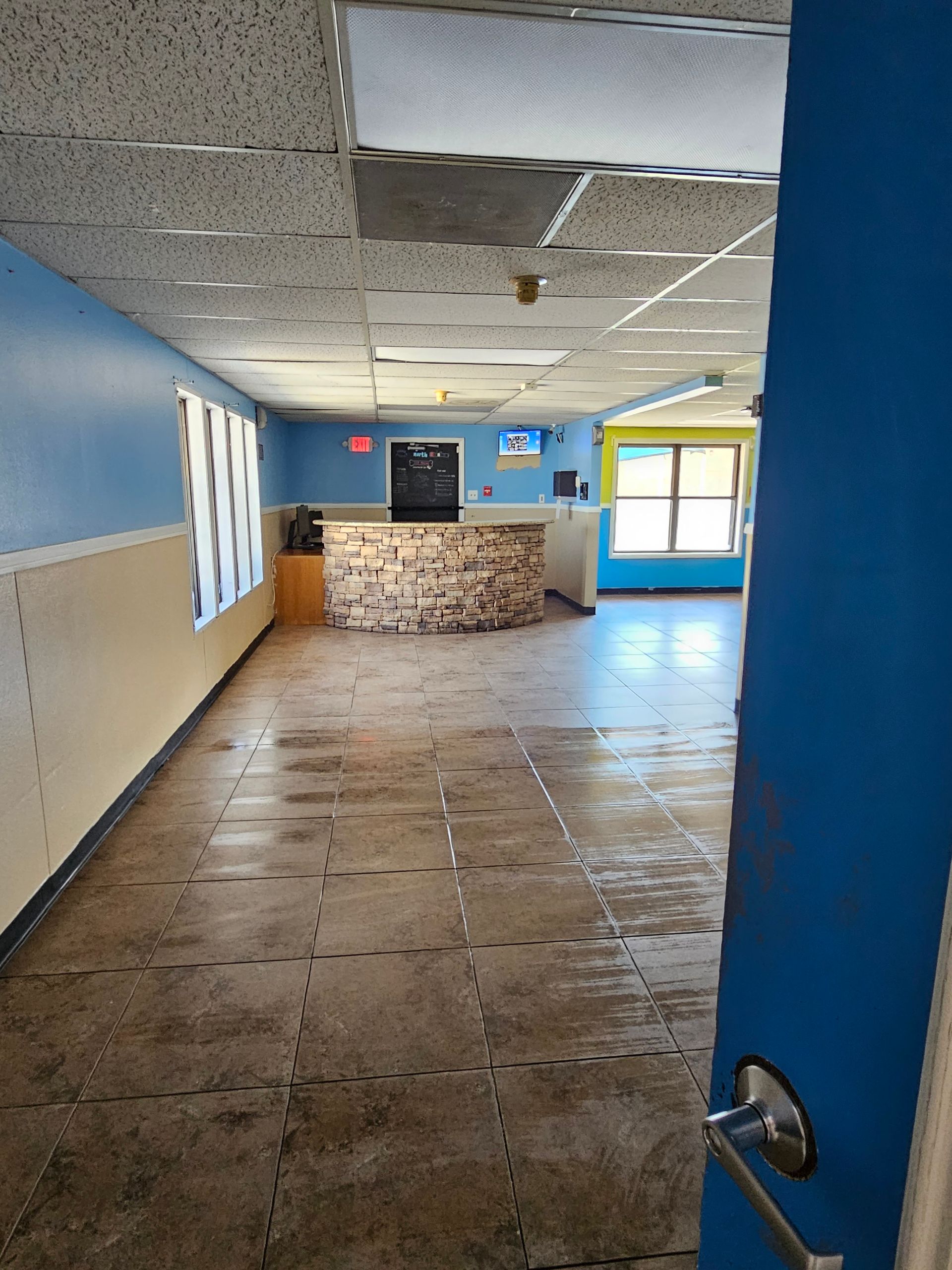 An empty hallway in a building with a blue door