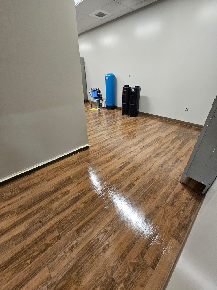 A room with a wooden floor and white walls.