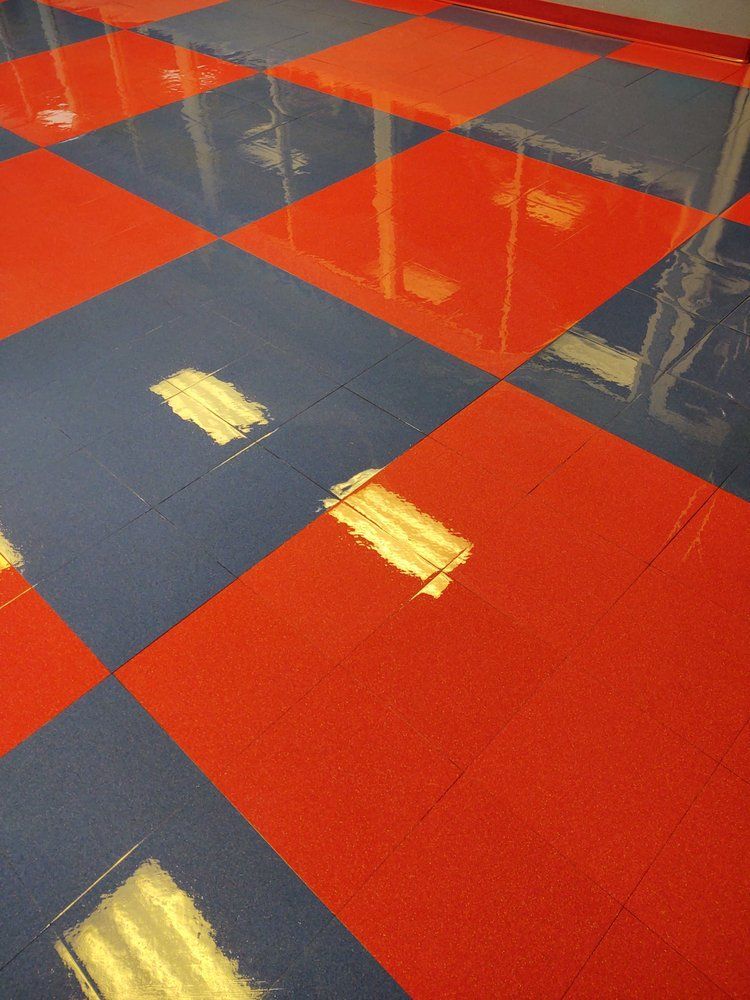 A red and blue checkered floor with a reflection of lights