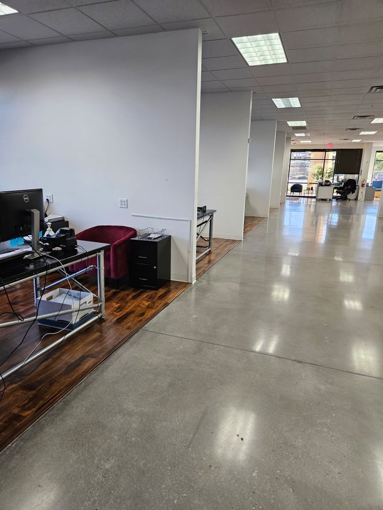 A large office with a lot of desks and chairs.