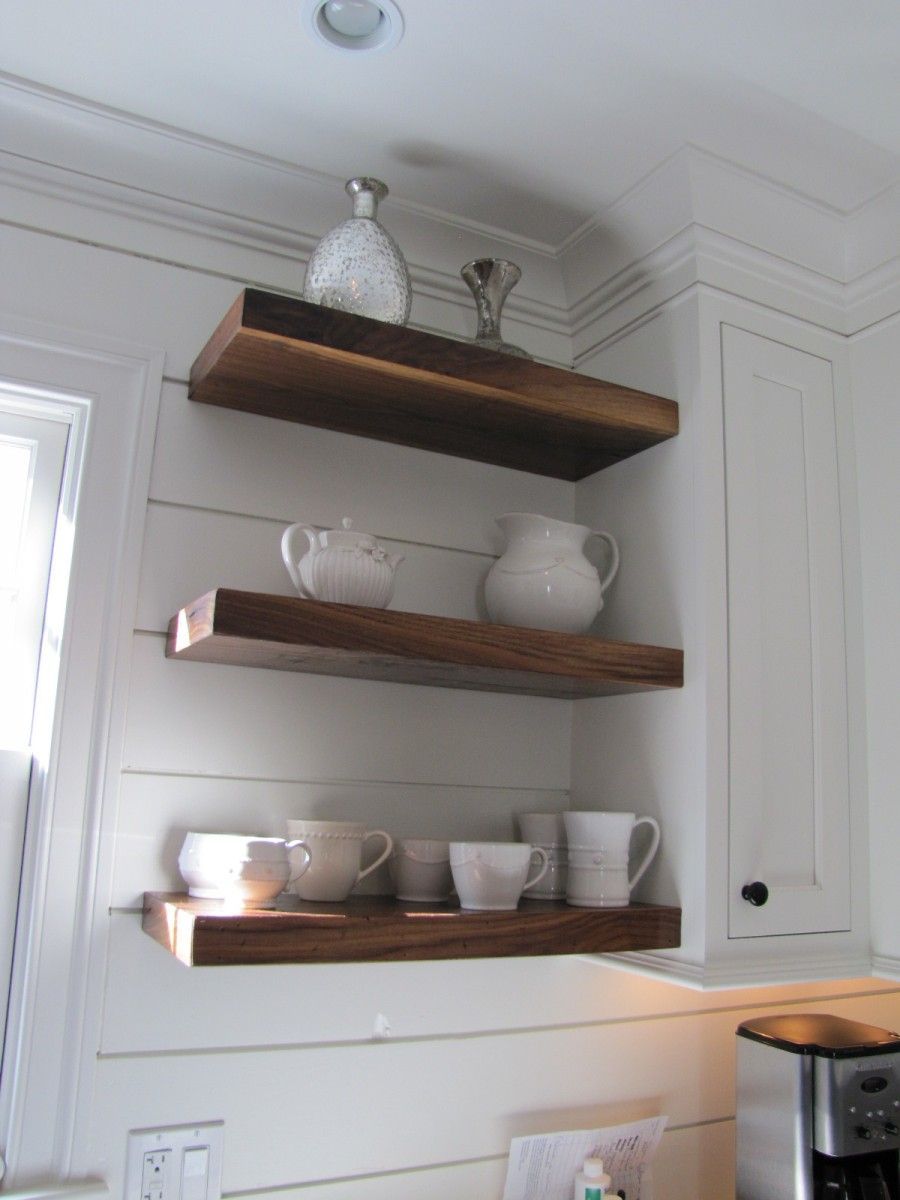 Walnut shelves on pine shiplap walls