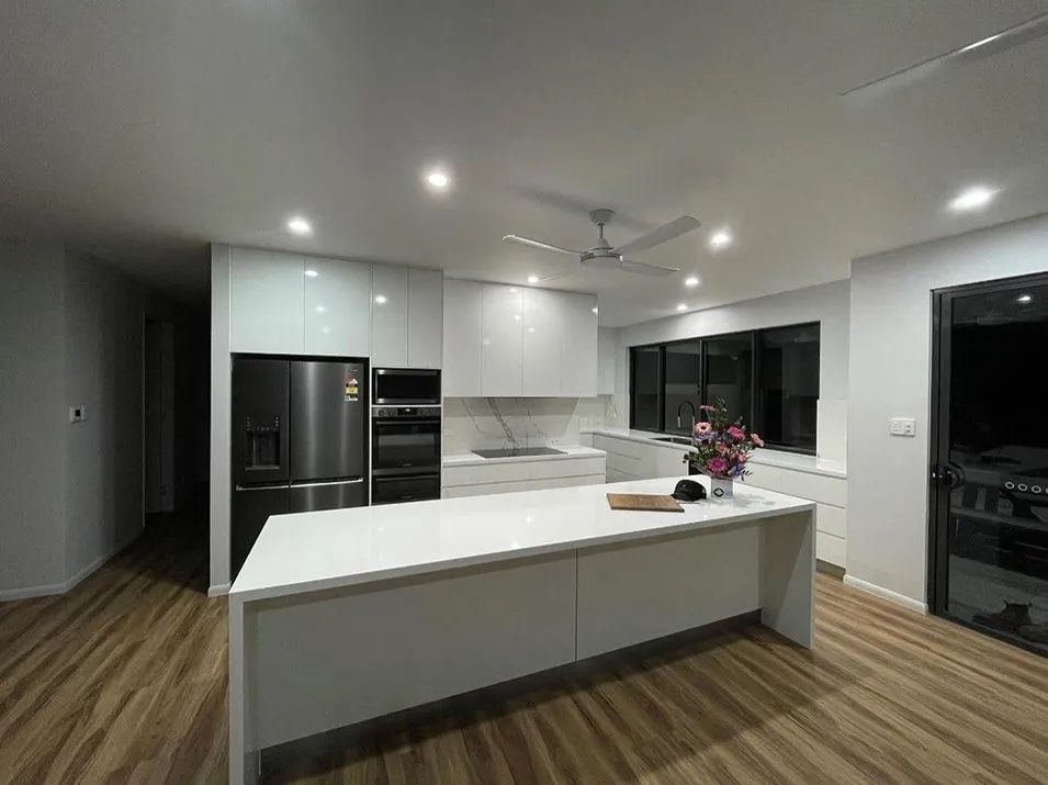 Modern White Kitchen With Island, Stainless Steel Appliances — Keilbach Kitchens in Cairns, QLD