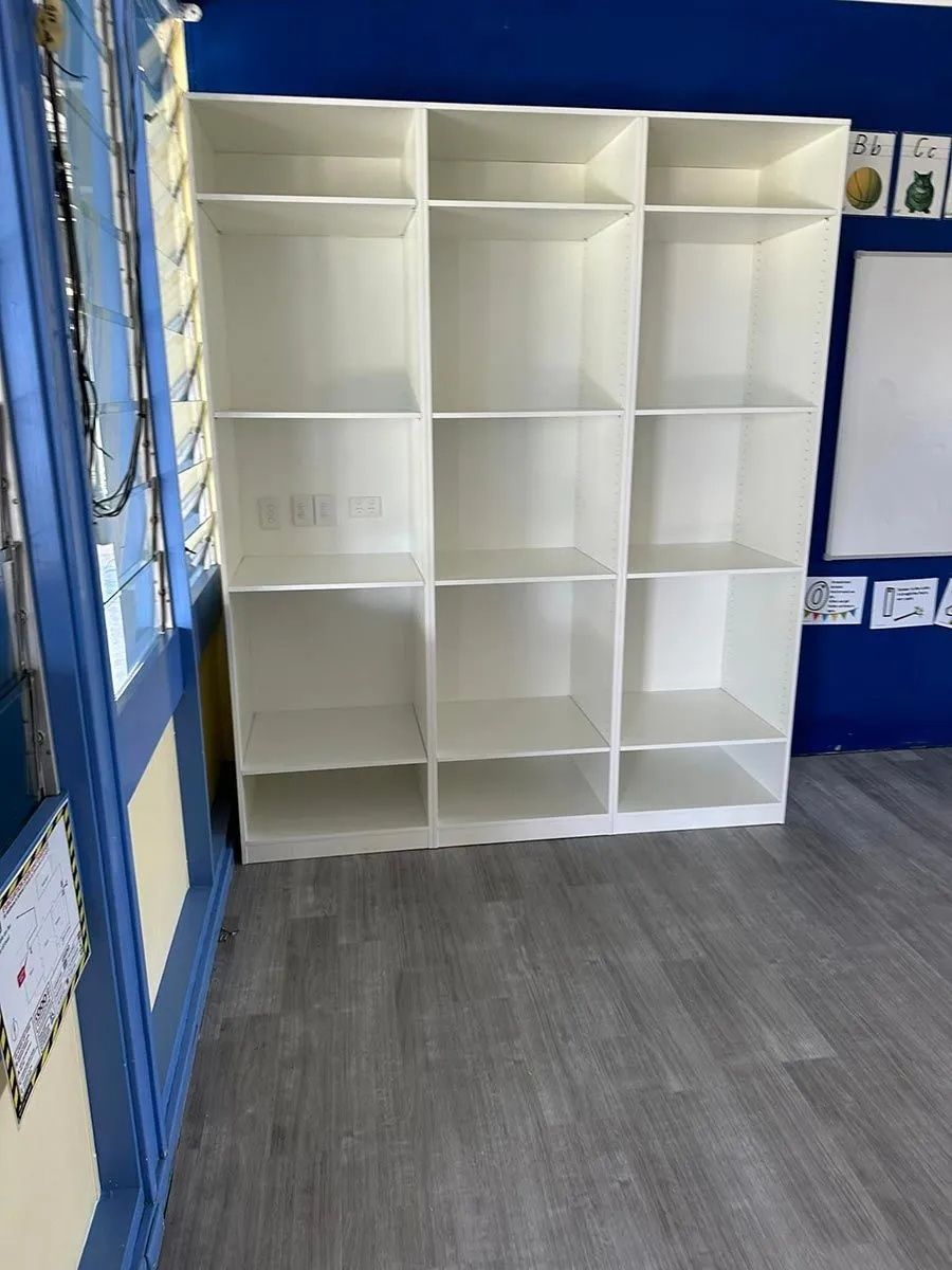 White Cubby Shelves Against a Blue Wall and Gray Floor — Keilbach Kitchens In Garradunga, QLD