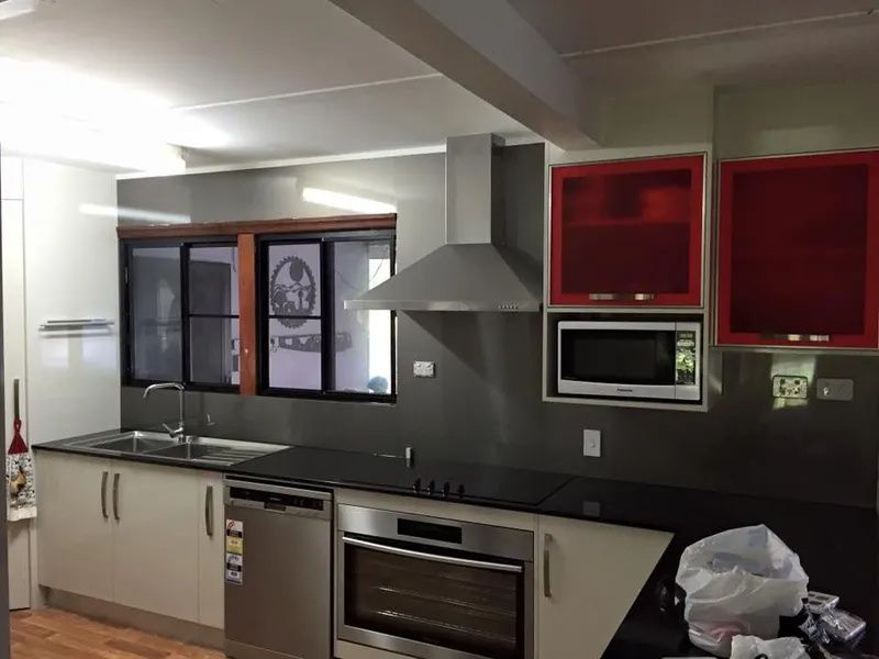Modern Kitchen With Red Cabinets — Keilbach Kitchens in Garradunga, QLD