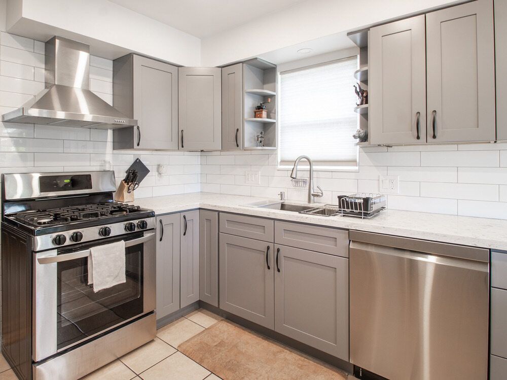 Gray and Stainless Steel Kitchen With Cabinets — Keilbach Kitchens in Garradunga, QLD