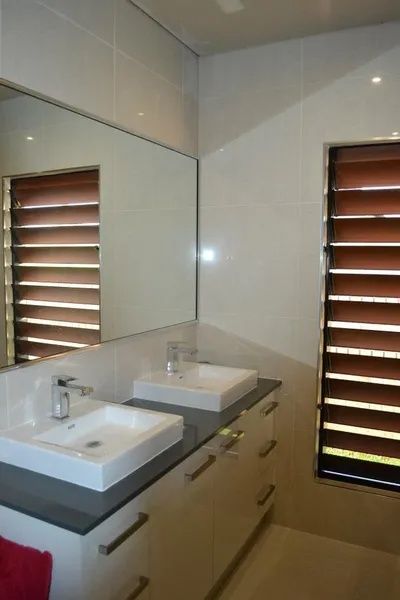 Bathroom With Two Sinks, a Large Mirror, and Brown Shuttered Windows — Keilbach Kitchens in Garradunga, QLD