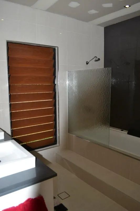 Bathroom With Wood Shutters — Keilbach Kitchens in Garradunga, QLD