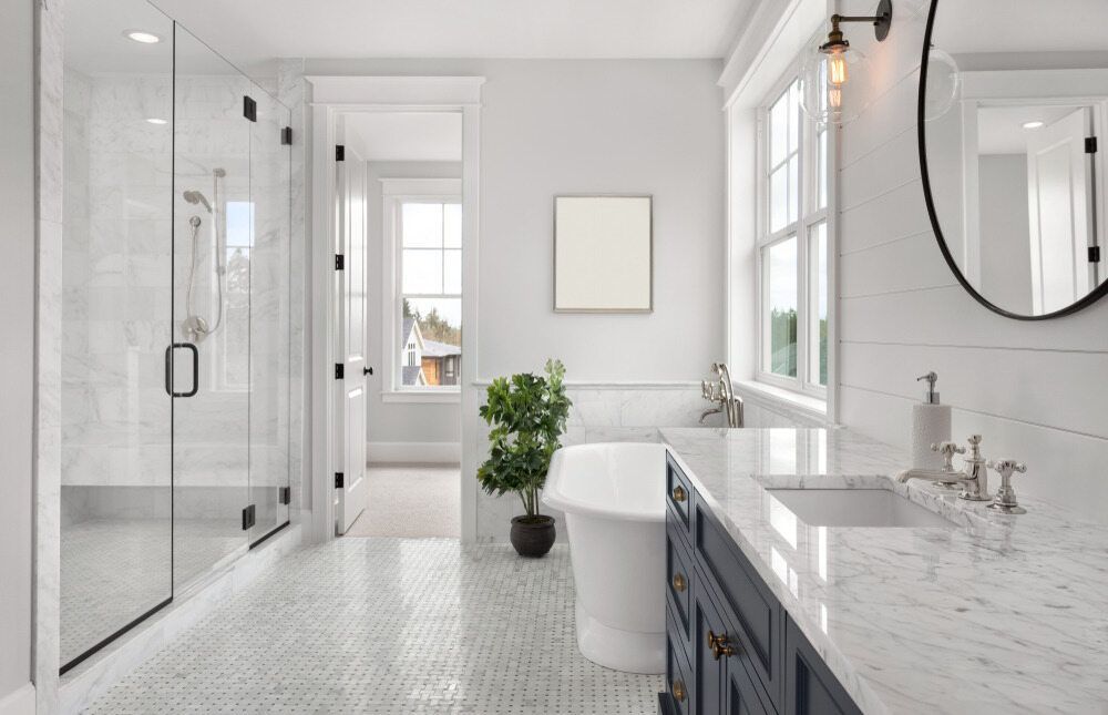 Bright White Bathroom With Marble Tile and Accents — Keilbach Kitchens in Cairns, QLD