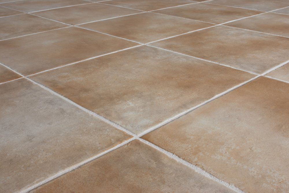 Beige tile floor, with white grout lines arranged in a diamond pattern.