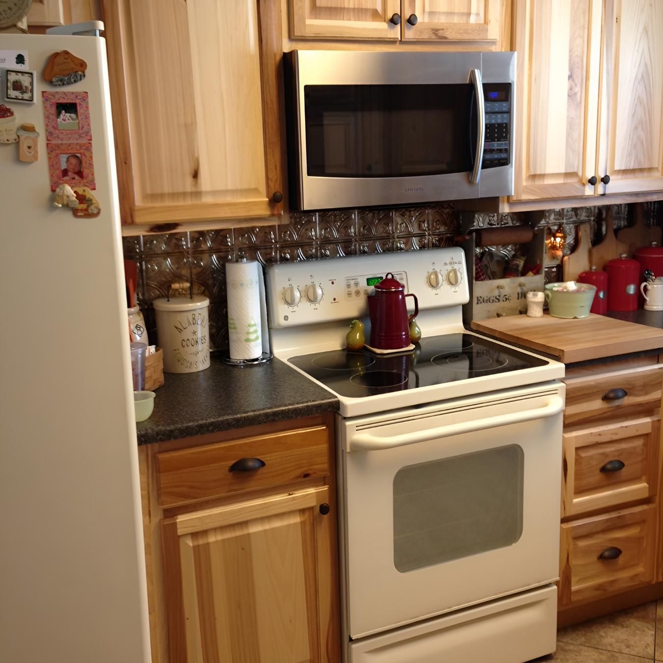 A Kitchen With a Stove Top Oven and a Microwave — Proud Cleaning Canberra in Amaroo, ACT
