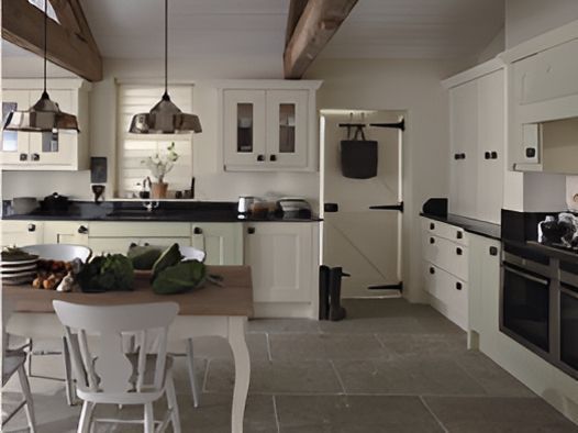 A Kitchen With White Cabinets and a Wooden Table — Proud Cleaning Canberra in Amaroo, ACT