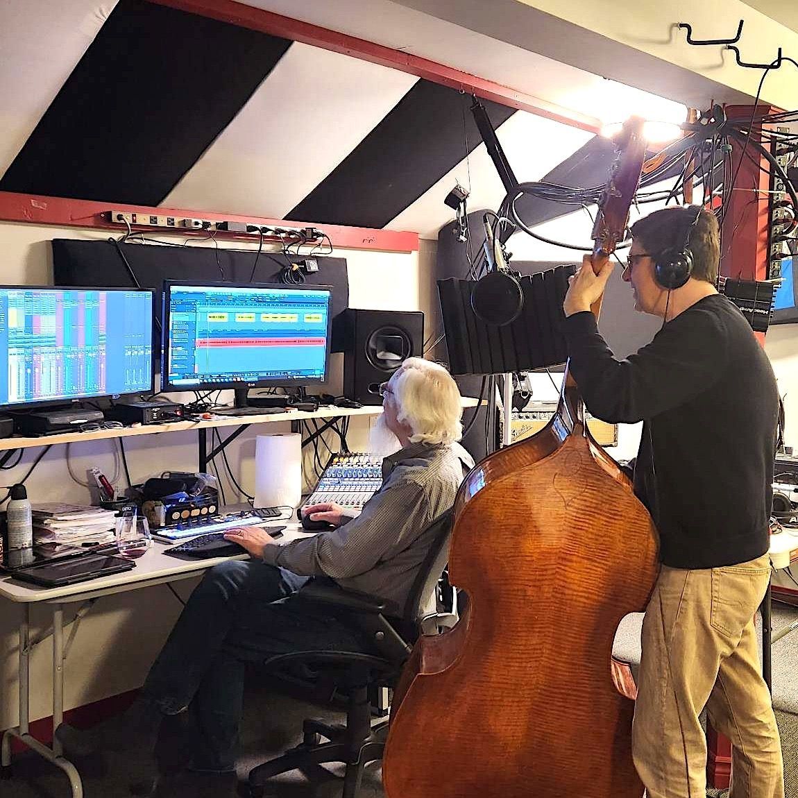 Randy and David of Bird River Band, in their studio, using computer software to edit a song after a recording session.