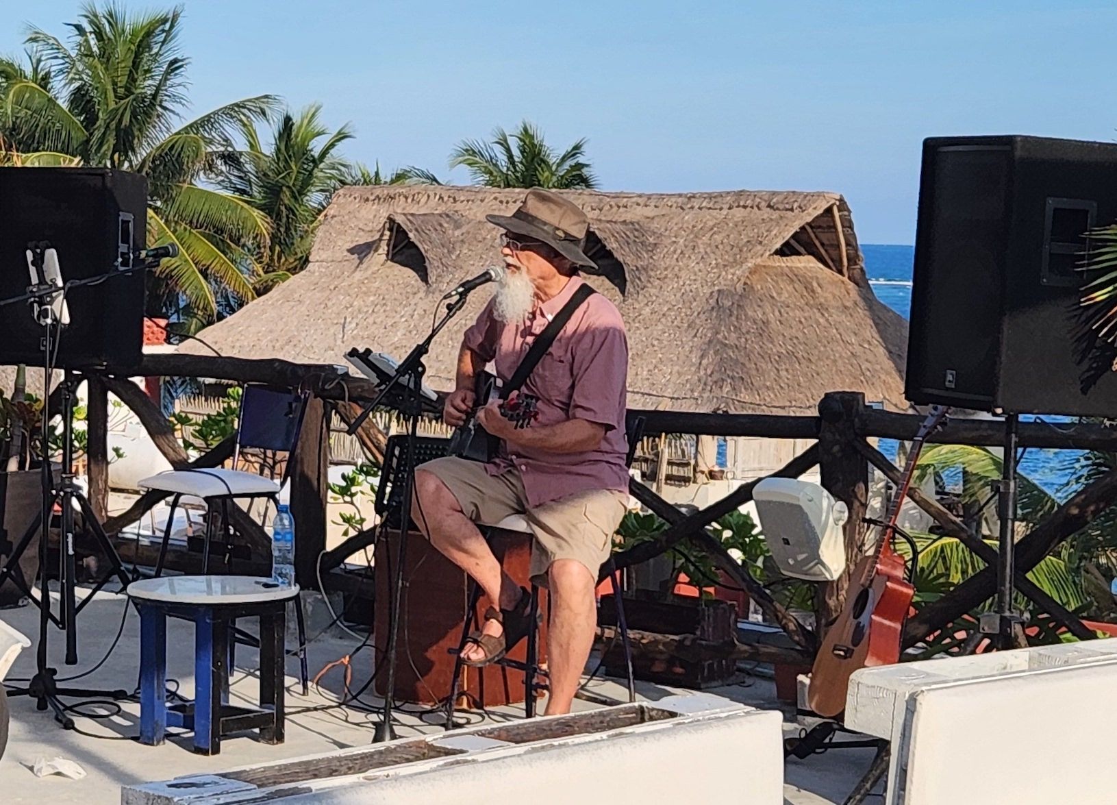 Randy playing acoustic guitar and singing in the microphone, while on tour down South in the winter.