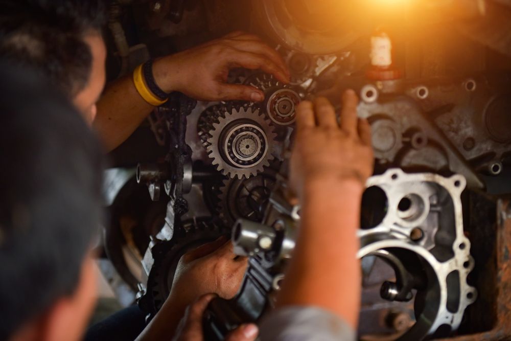 Mechanics Working On Engine Gears, Illuminated By Bright Light — KND Autos in Berrimah, NT