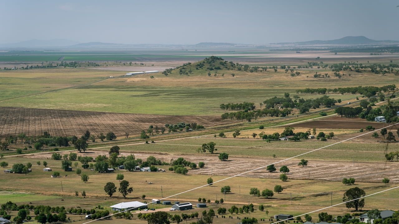 An Aerial View of A Lush Green Field with Trees and A Lake in The Background — A1 Windscreens in Gunnedah, NSW