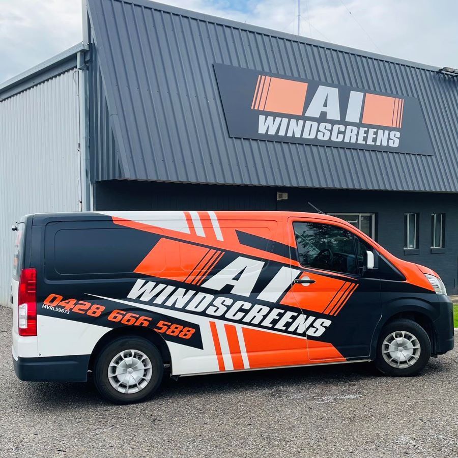 A Van With Ai Windscreen Branding Parked in Front of a Building — A1 Windscreens in Taminda, NSW