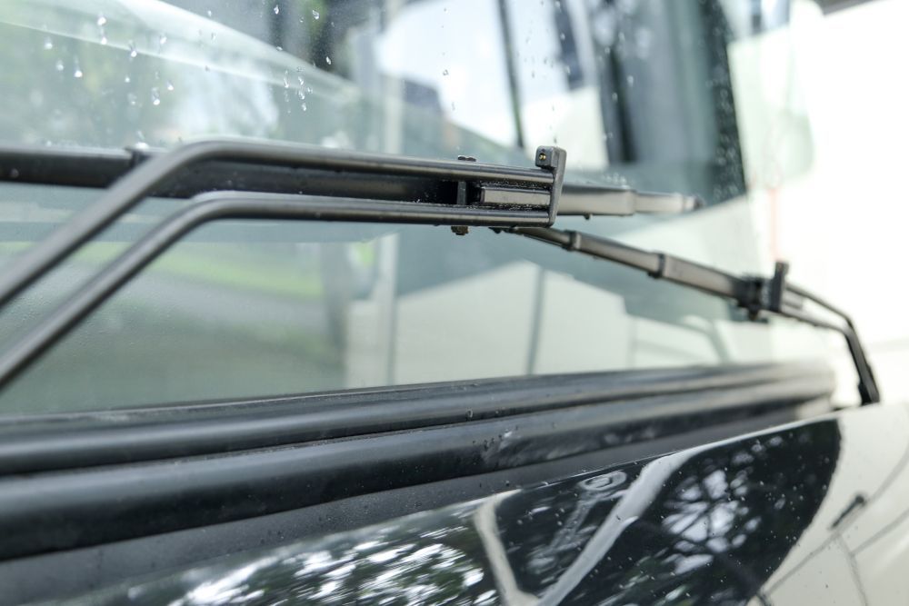 Black Windshield Wipers Resting on a Vehicle's Windshield