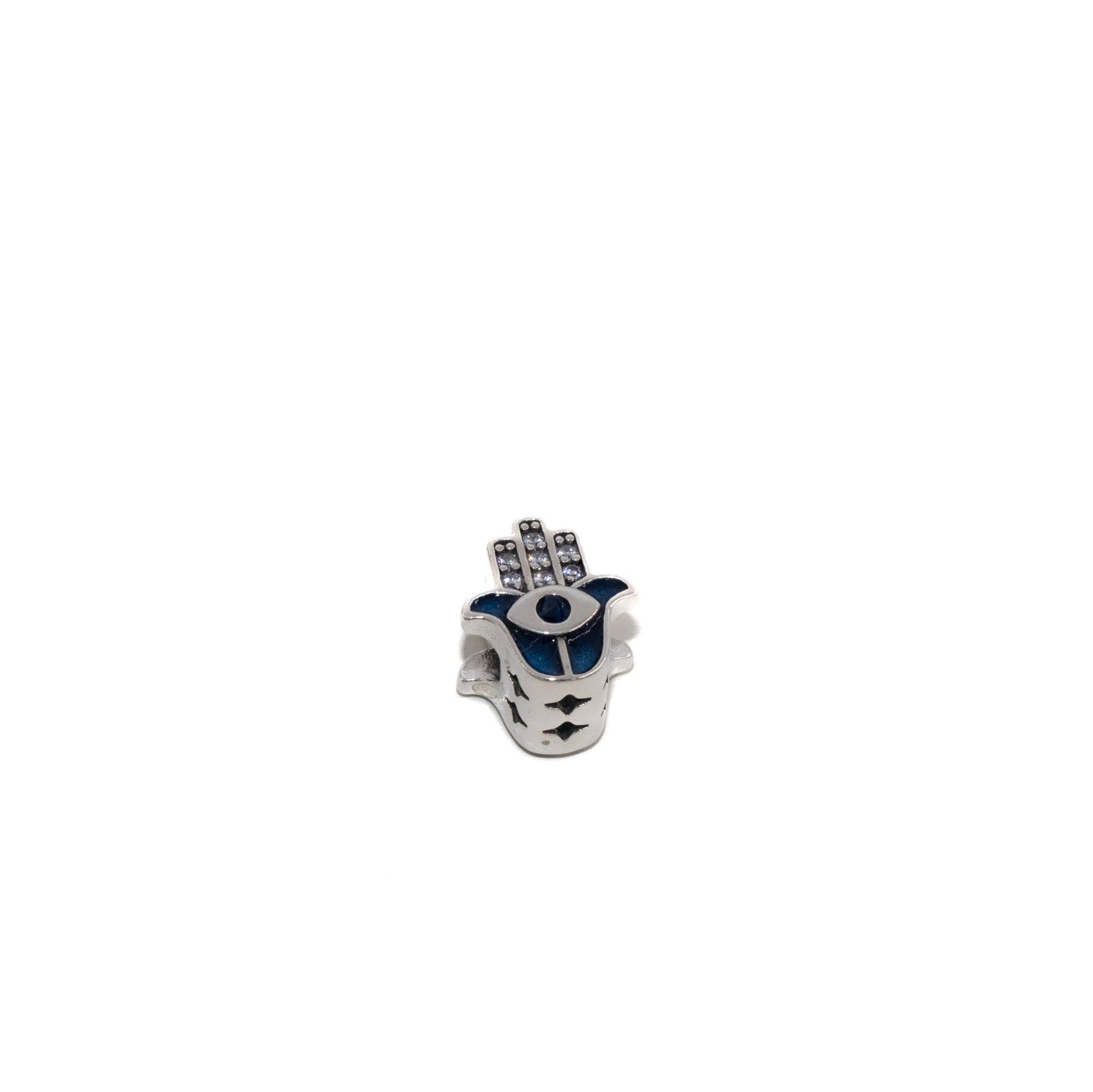 Pequeña figura decorativa plateada y azul con estrellas sobre fondo blanco.