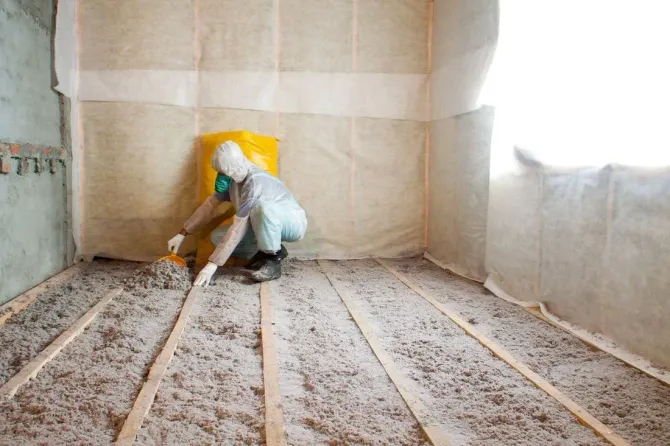 a man installing blown in insulation