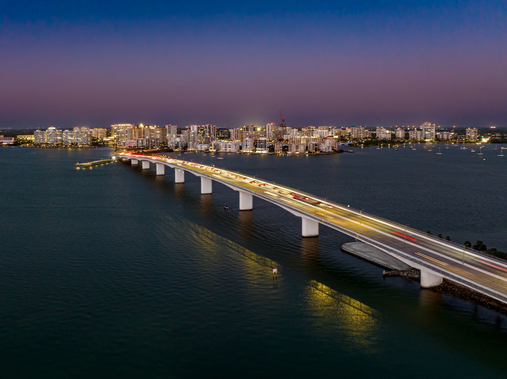 An aerial view of Sarasota and a bridge over a body of water