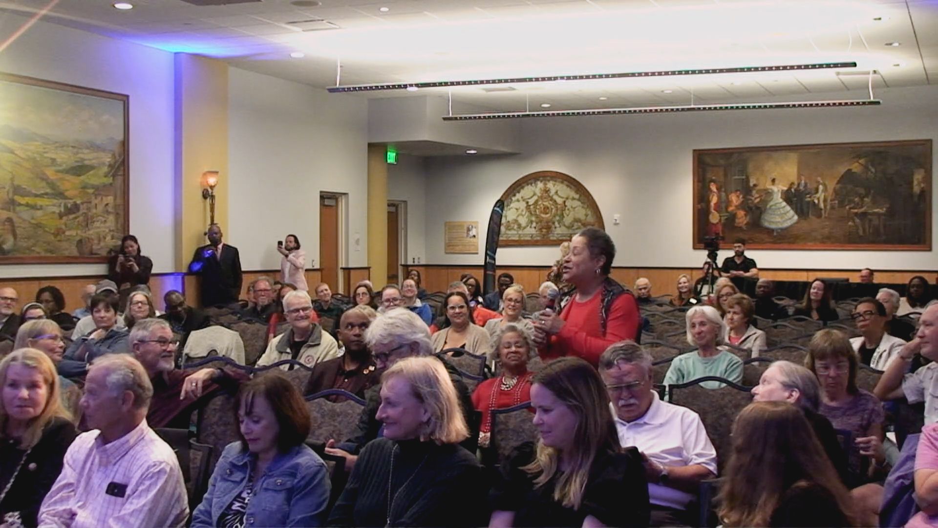 A large group of people are sitting in a room.