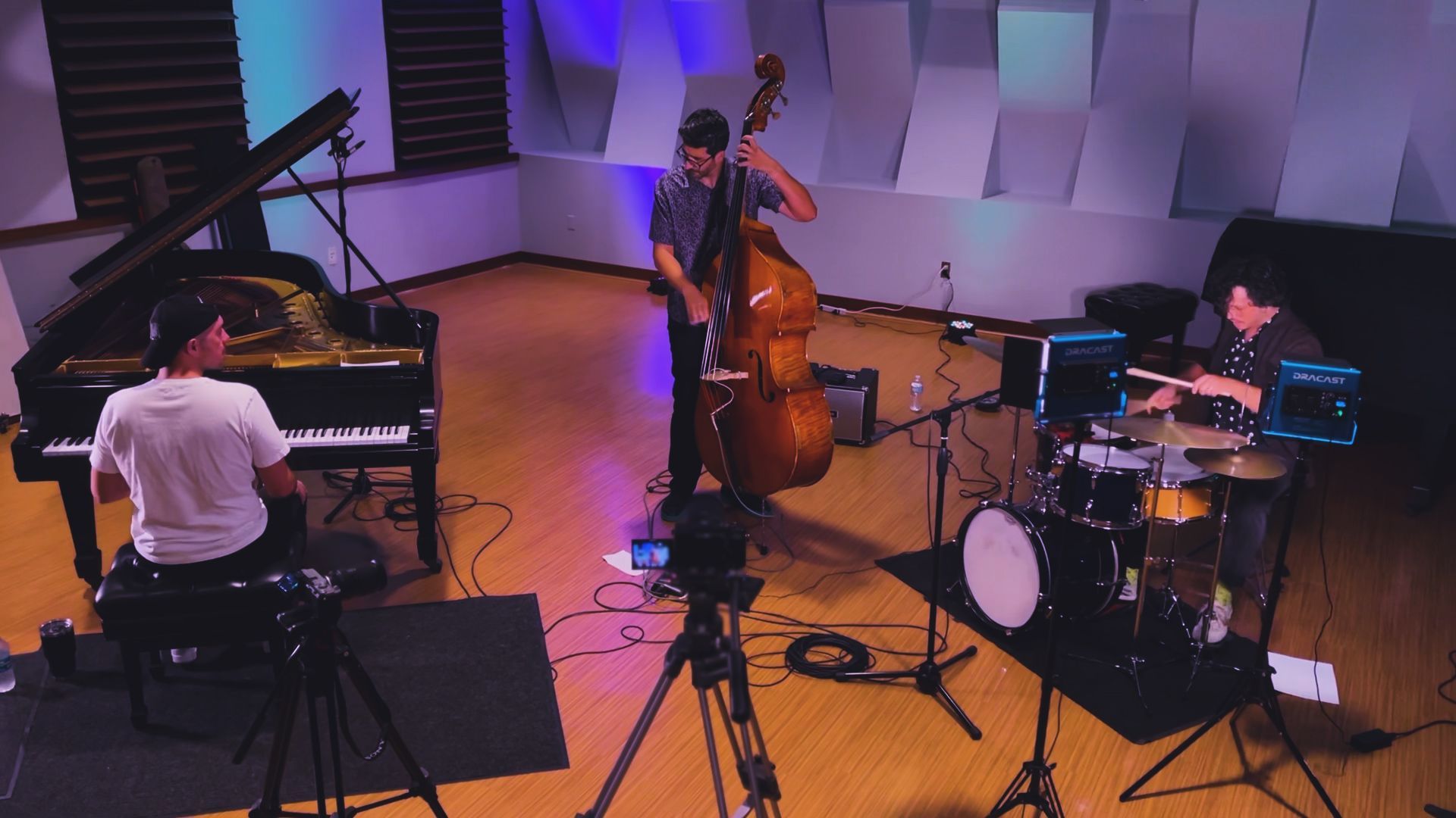 A group of people are playing instruments in a room.