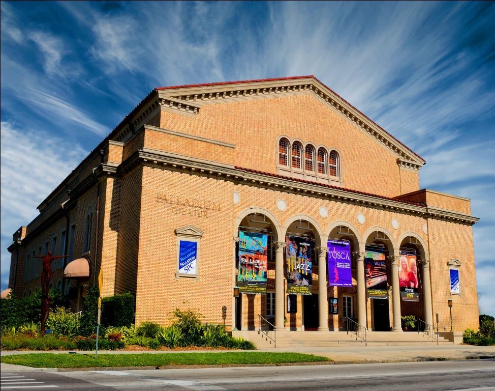 A large brick building with a blue sky in the background