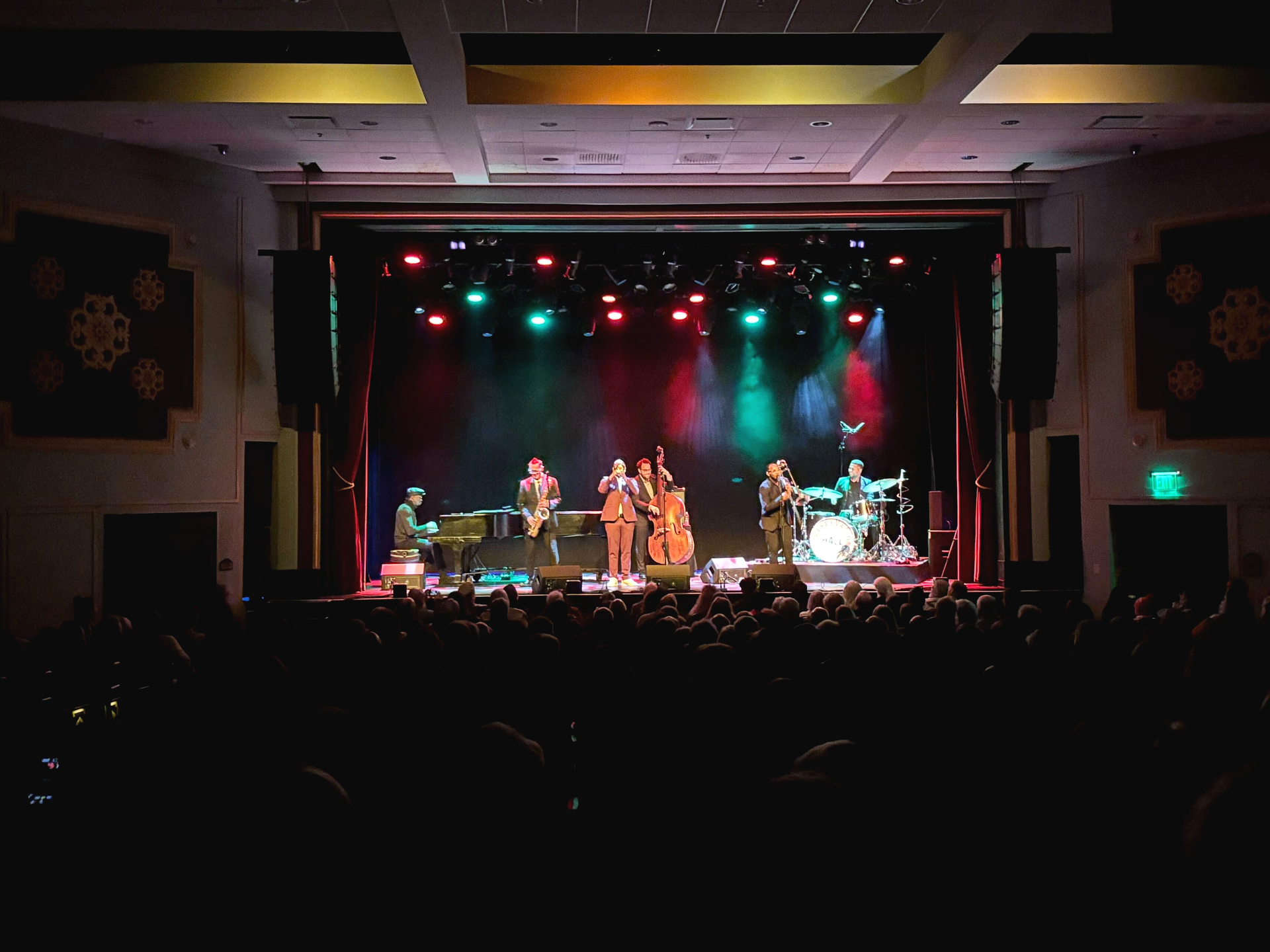 A band is playing on a stage in front of a crowd
