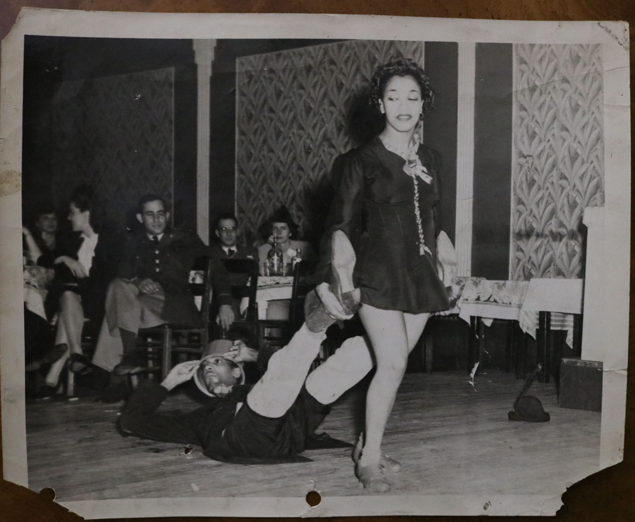 A black and white photo of a woman dancing on a stage