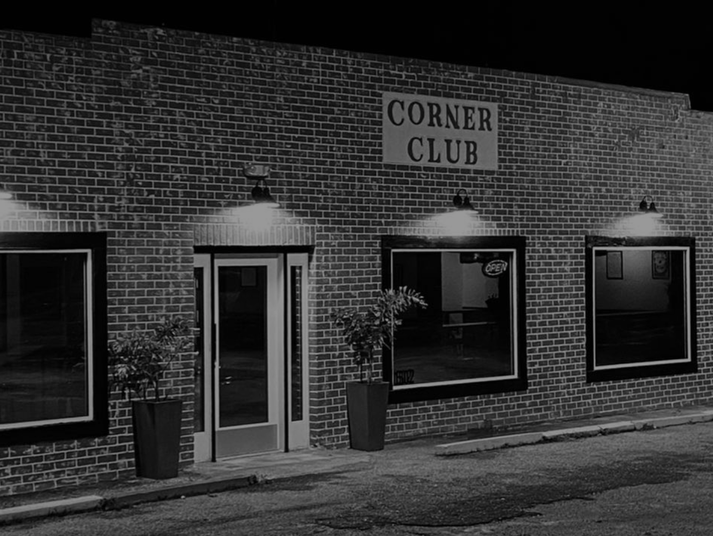 A black and white photo of the corner club