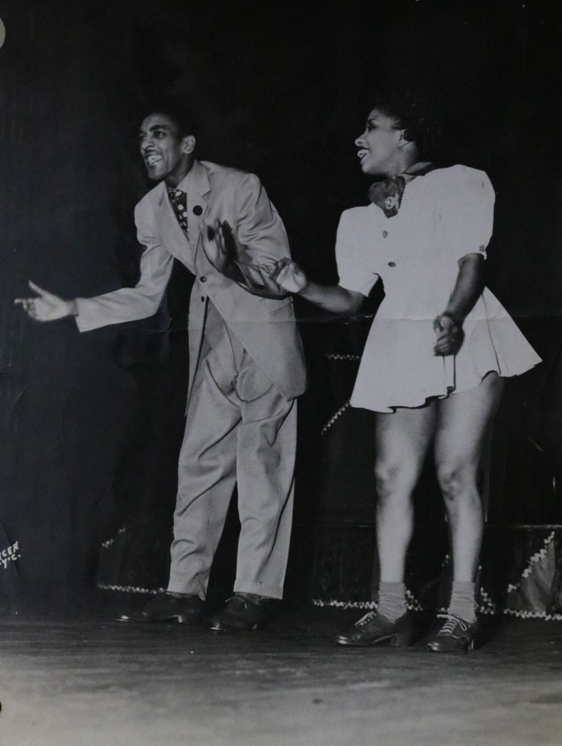 A black and white photo of a man and woman dancing