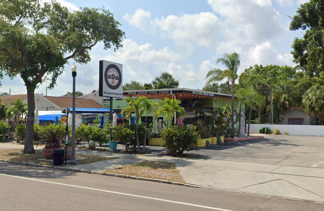 A parking lot in front of a building with a sign that says no parking