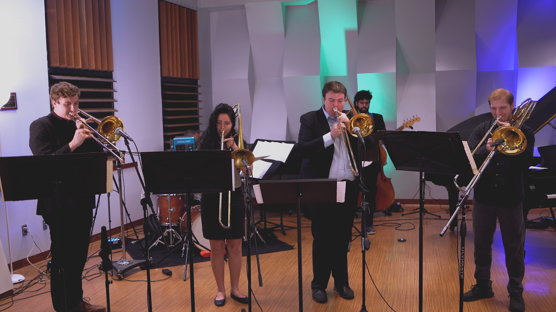 A group of people are playing instruments in a room.