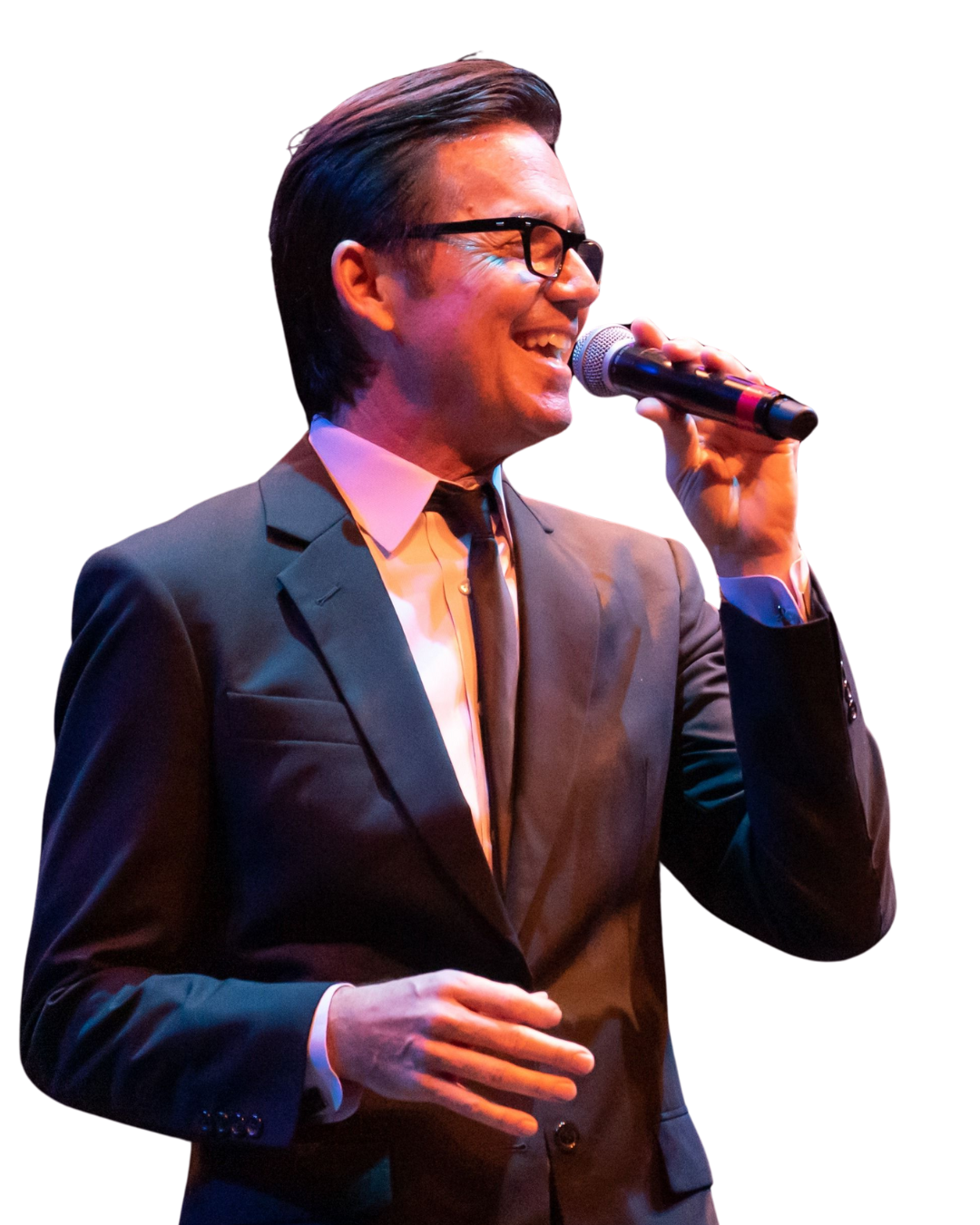 A man in a suit and tie is singing into a microphone.