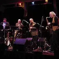 a group of men are playing instruments on a stage .