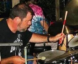 a man is playing drums in a band .