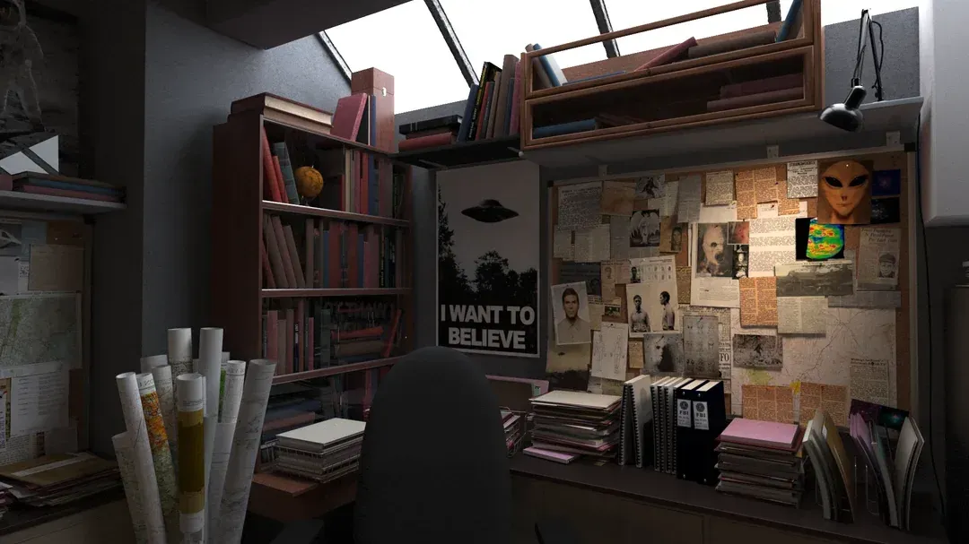 Cluttered art desk in a dim attic room with sketches, posters, books, and sunlight from skylights.