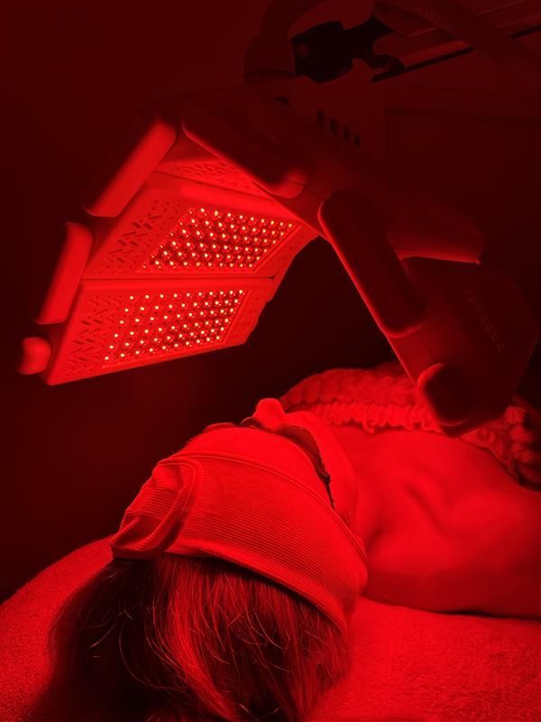 Person undergoing light therapy with orange lights focused on their face — Bombshell Body Bar In Meikleville Hill, QLD