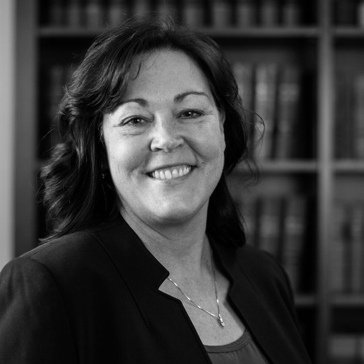 a black and white photo of a smiling woman