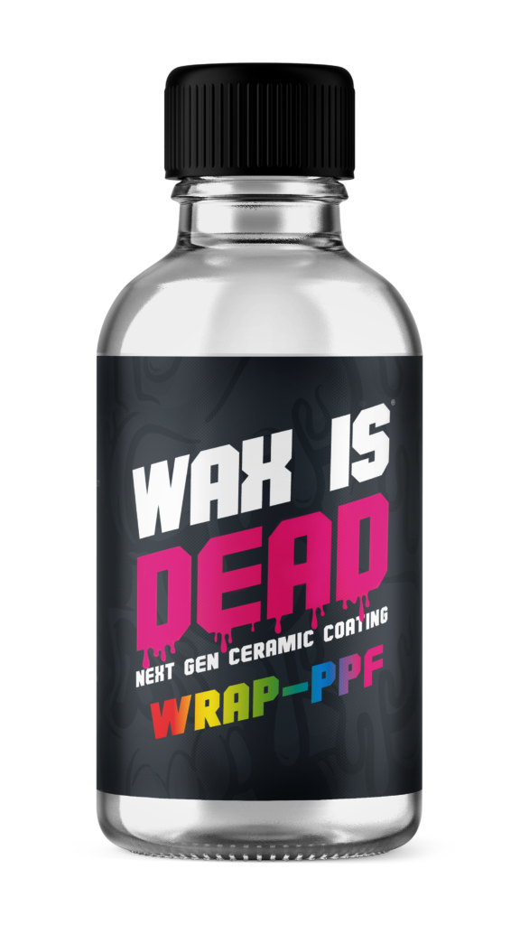 Small clear bottle with black cap and label reading “WAK IS DEAD” in white, pink, and yellow text.